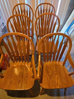 6 solid oak chairs with oak table that has  2 extesions