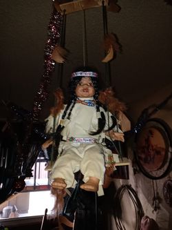 Antique doll on a swing