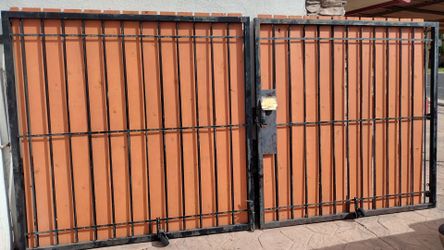 Black metal door gate. Wood panel.  Size. 14' feet wide X .6 '  1/2 ' feet tall. .good condition ..   $. 395 .