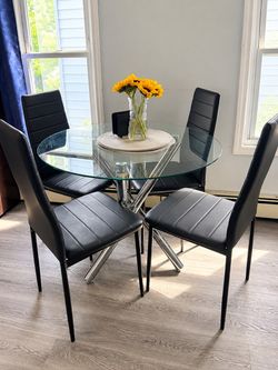 Dining table with 4 chairs .