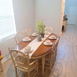 Dining Room Table With Dishware And Chairs 