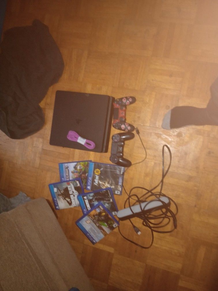 PS4 Slim With One New Controller And One Used Console In Good Condition Comes With 5 Games And More. Comes With A Led Light Bar With It And All It's W