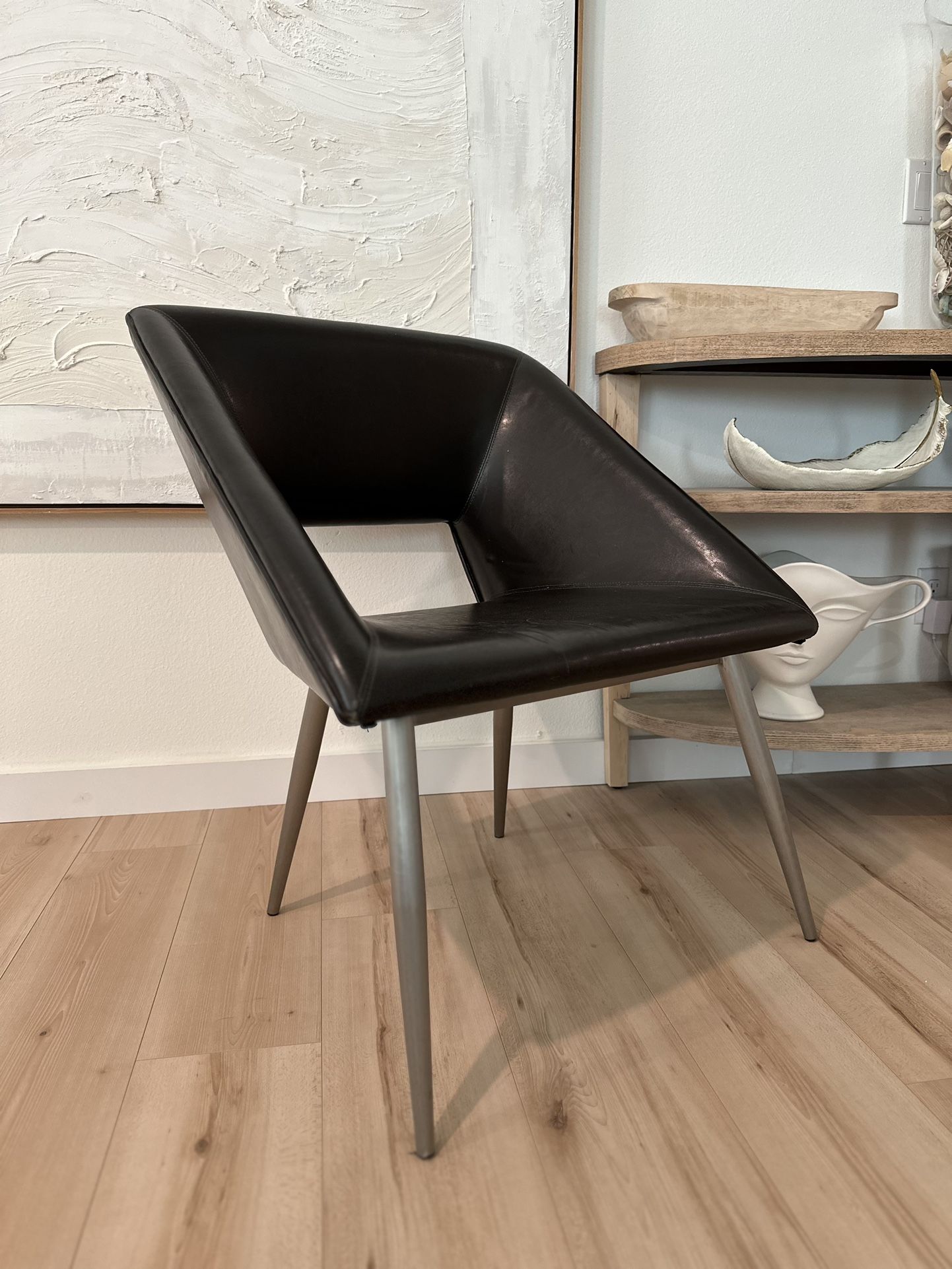 Pier 1 leather black chair In good condition but has small tear in back corner See in photo 17 inches tall 27 inches wide