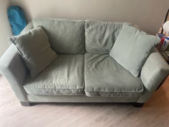 Pale green loveseat couch