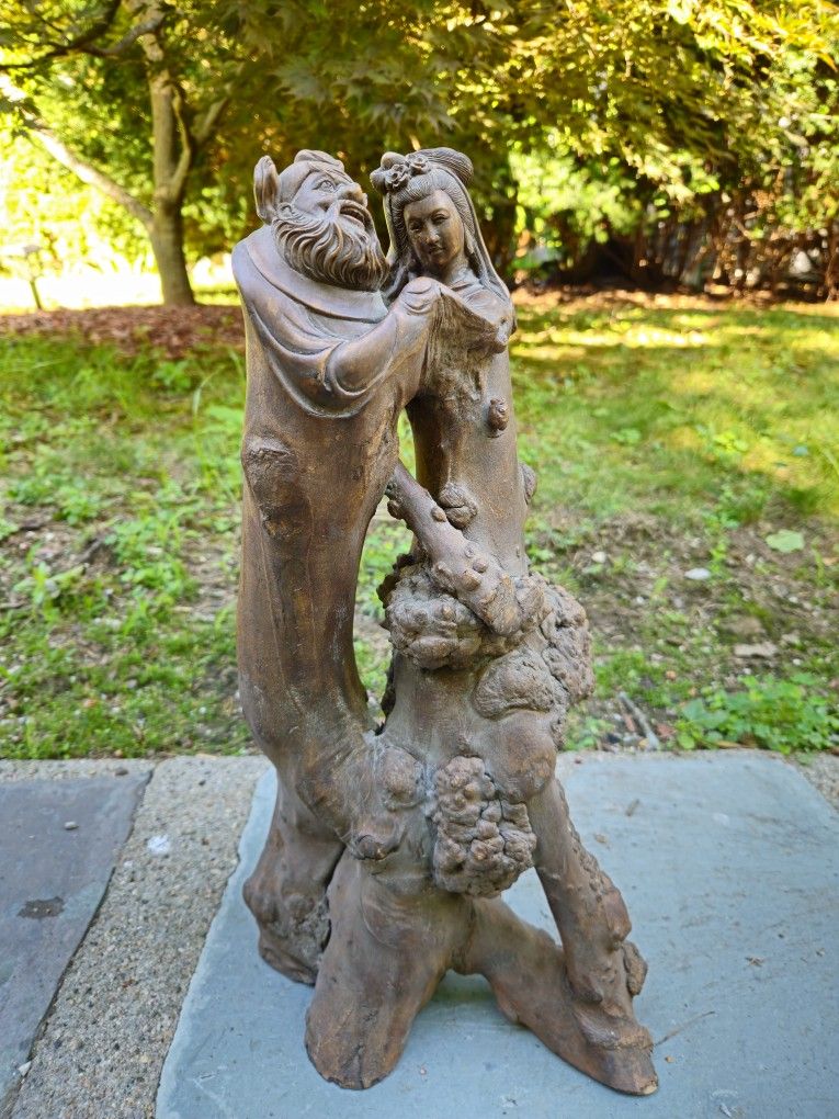 Japanese-style root wood carving, emerging from a natural root formation.