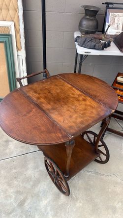 vintage wooden drop-leaf rolling tea cart or serving trolley