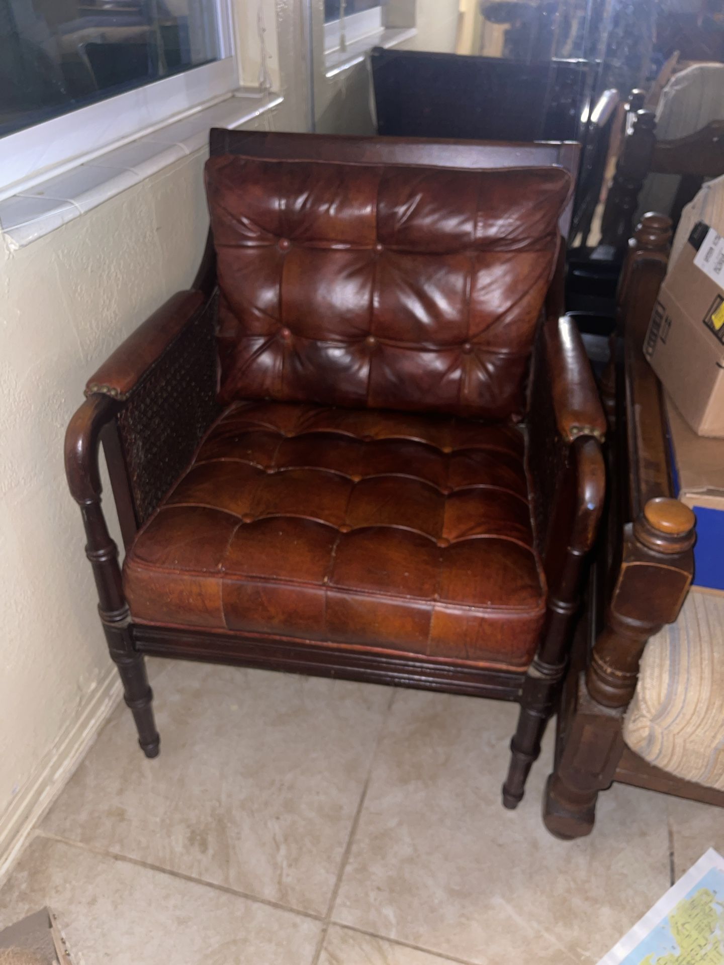 vintage tufted leather armchair with cane sides and turned wood legs From The 1950s /1980s