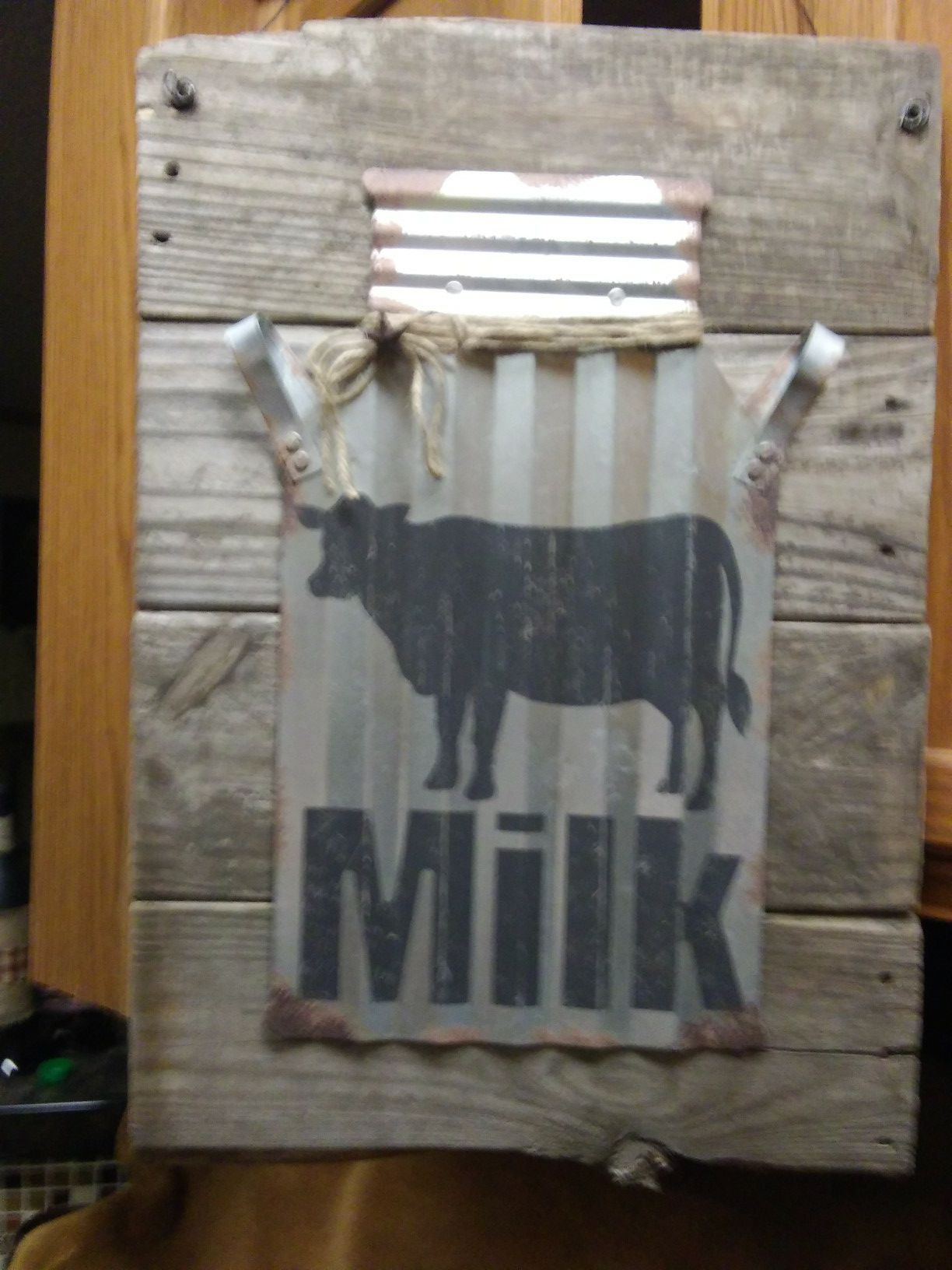 Handmade sign with corrugated metal milk can