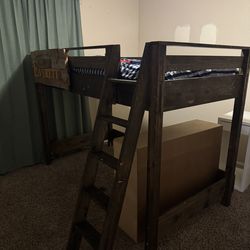 Twin high bed with ladder.  Lots of room for desk and or book shelve. Very sturdy.