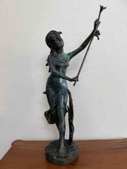Art Nouveau bronze style sculpture of a young female raising a branch and two birds perched