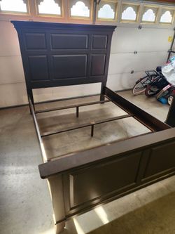 Wooden queen size bed frame.