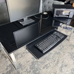 Black Glass desk with metal legs. Also included are new leather computer chair, Acer Monitor, Epson printer and Logitech keyboard.