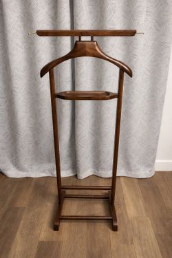 Wooden Valet Stand – Excellent Condition  Elegant wooden valet stand, perfect for keeping your clothes organized and wrinkle-free. Great for suits, sh