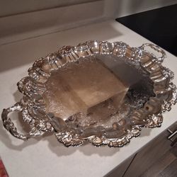 Vintage Sheridan silverplated tray features a shell and gadroon edge design. 