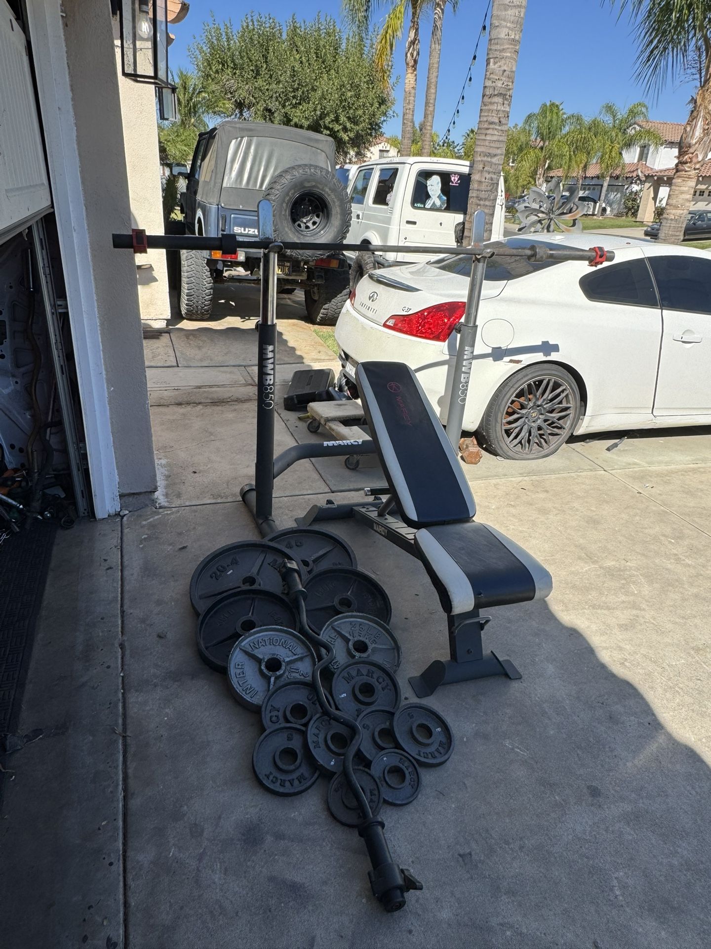 Bench press/squat rack with 7ft 45lbs bar plus 255lbs of Olympic weights and curl bar