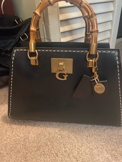 Adorable, authentic black Guess handbag with unique bamboo handles. Like New.