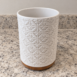 White ceramic utensil holder with wooden base