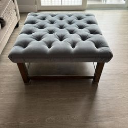 Coffee table with cushion top and storage