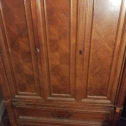 antique armoire the top opens with three drawers and the bottom has two drawers with dividers solid wood