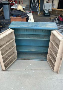 A vintage mechanics cabinet and two garage stools