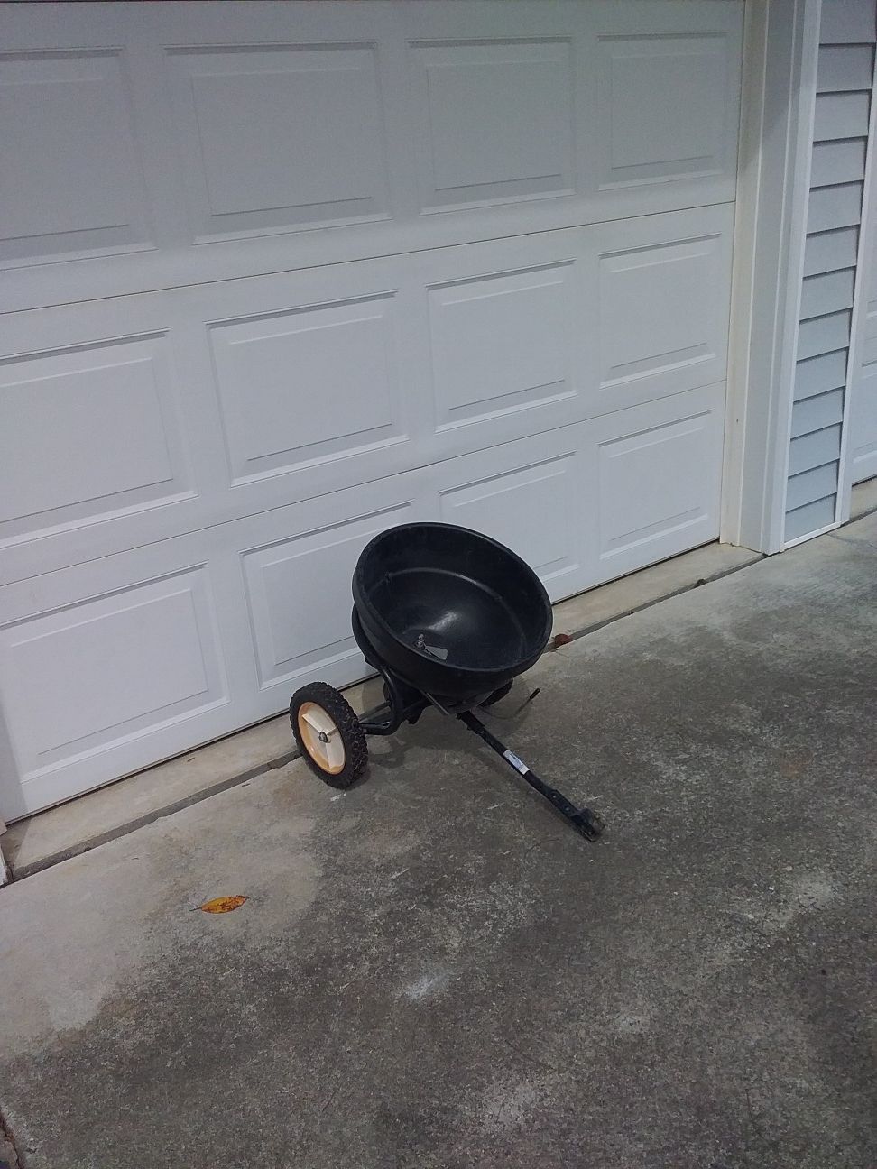 Pull behind mower spreader