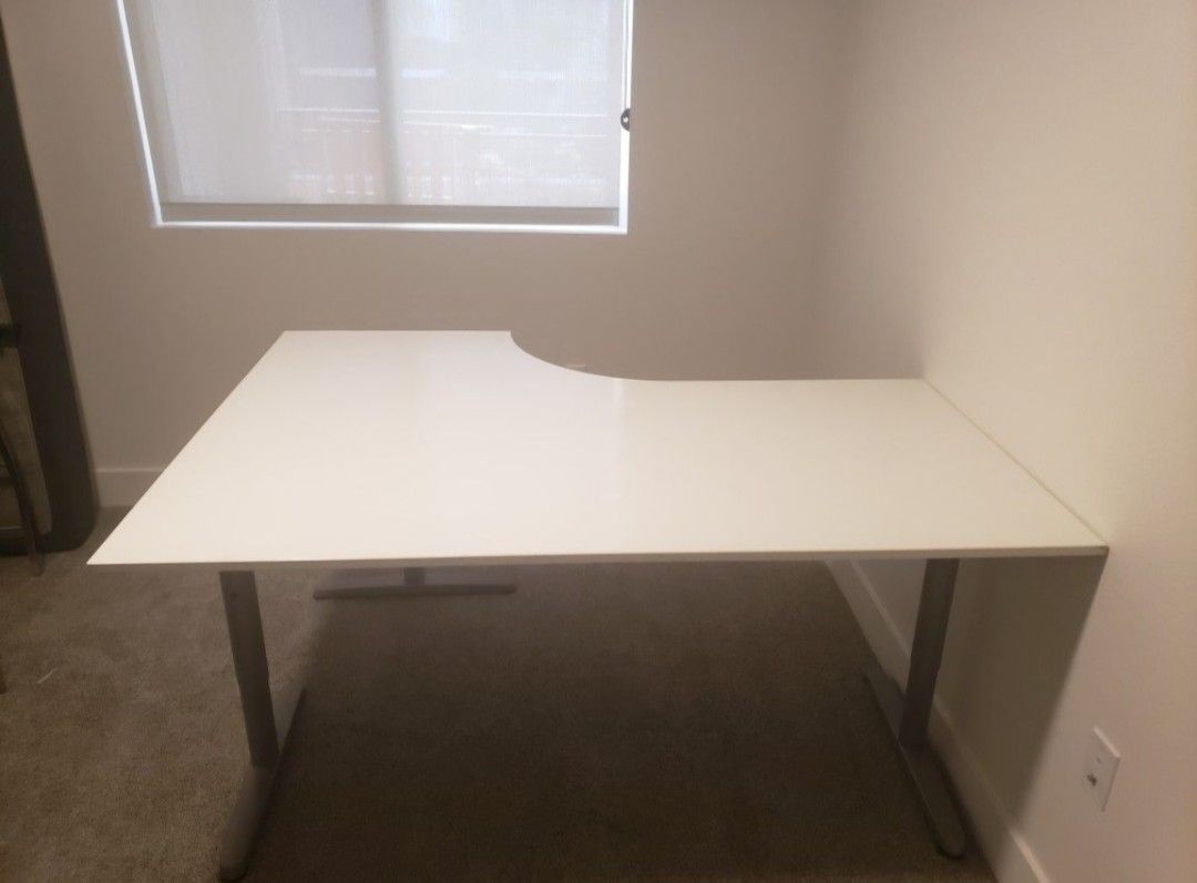 White Ikea Galant L-shape desk.