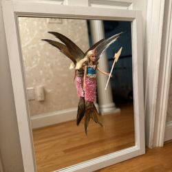 Barbie mermaid battle, fairy taxidermy on a mirror