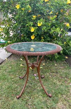 Outdoor metal patio table with glass top wicker edge