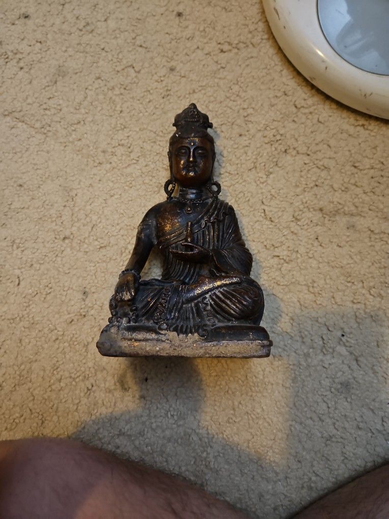 Old Buddhist Peace Metal Statue
