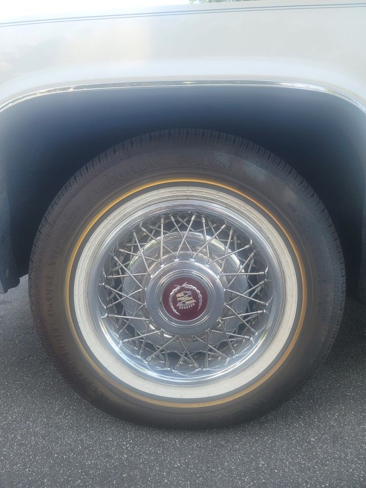 90's Cadillac trim And Vouge Tires With Cap And Locks