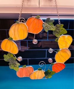 Beautiful and perfect for Fall! Handmade stained glass pumpkin wreath with green metal leaves in a metal frame