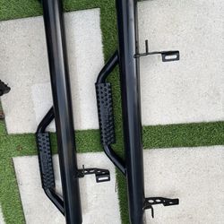 Jeep Wrangler JK 4-Door N-Fab Wheel 2 Wheel Nerf Side Step Bars; Textured Black