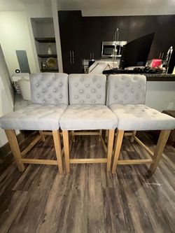 3 gray upholstered counter height chairs