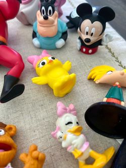 Toy Collection of figurines, dress up shoes, and PJ Mask characters and vehicles