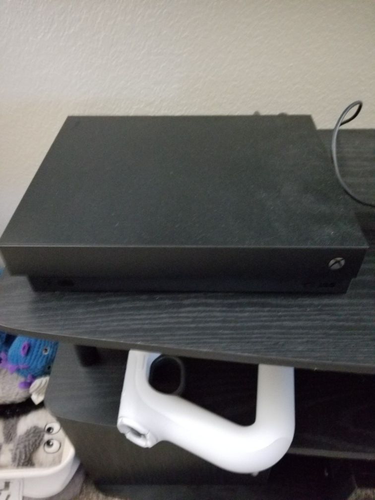 Xbox one x with 3 controllers and 2 games.