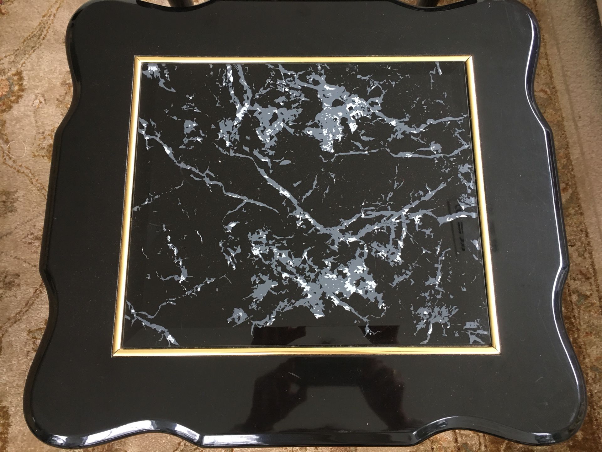 Two black and gold side tables