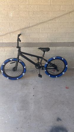 Black Mongoose BMX bike with 20” blue/white/camouflage tires