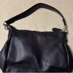 Black leather shoulder bag with silver hardware, featuring a unique design #leatherbag #shoulderbag