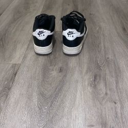 Black and white Air Forces Ones 