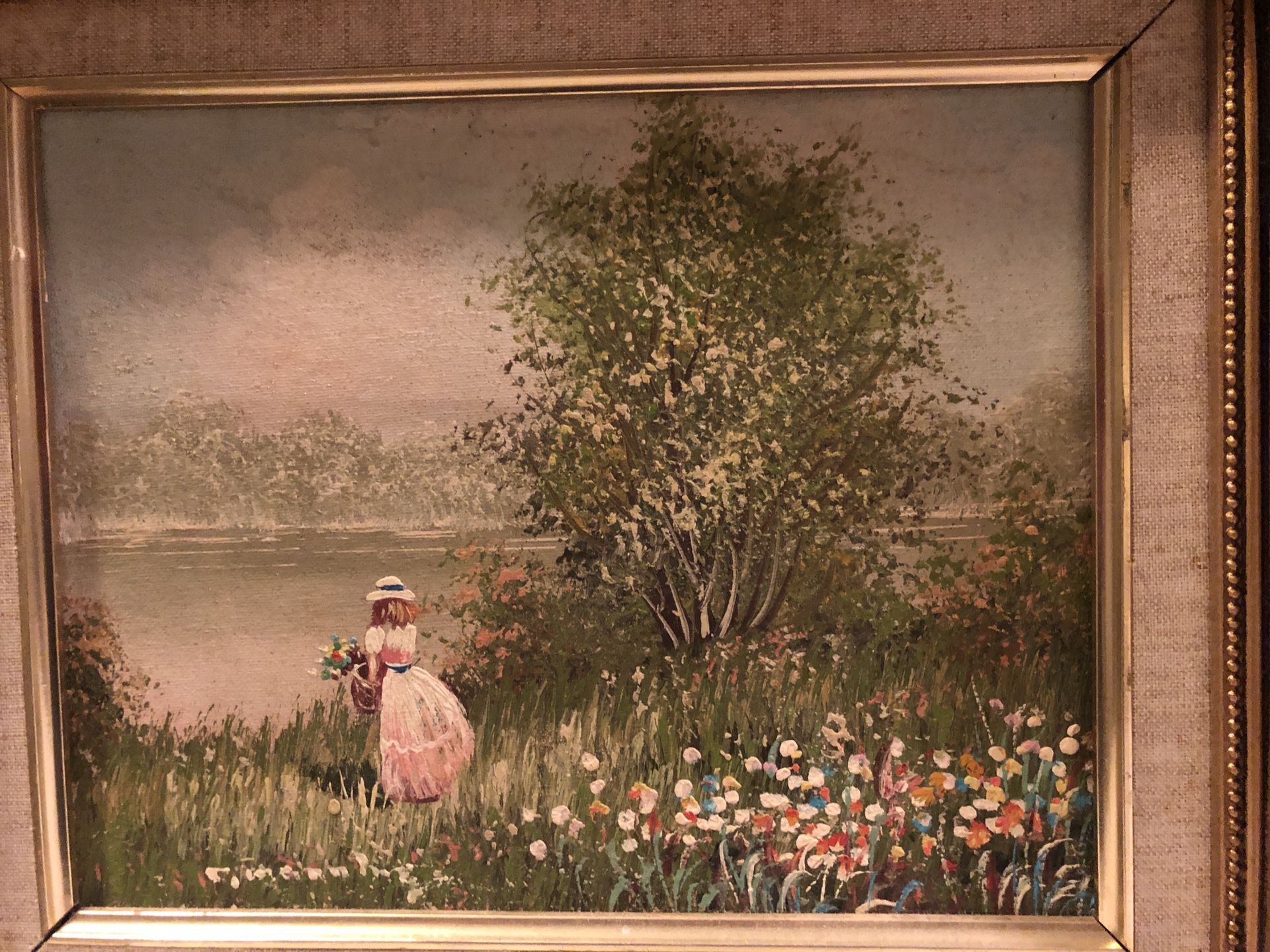 Wood- Framed oil painting of a girl standing by the lake