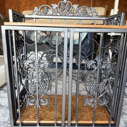 decorative wine rack or wine cabinet with a grape and vine motif. 