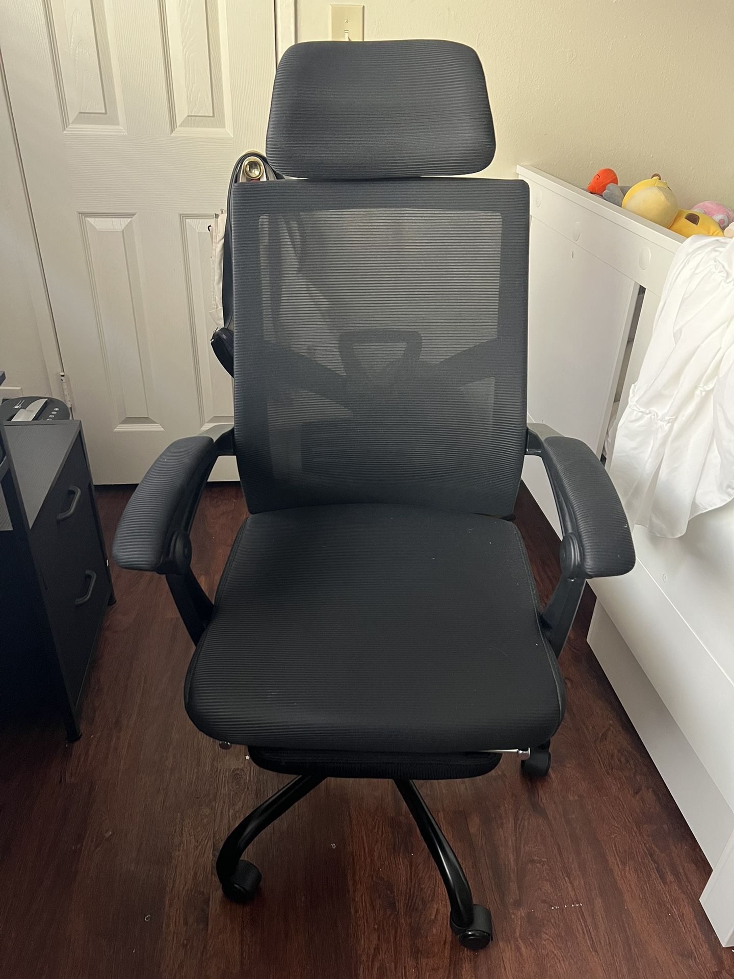 black mesh office chair with footrest and wheels