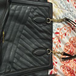 quilted tote bag in black with gold-tone hardware. 
