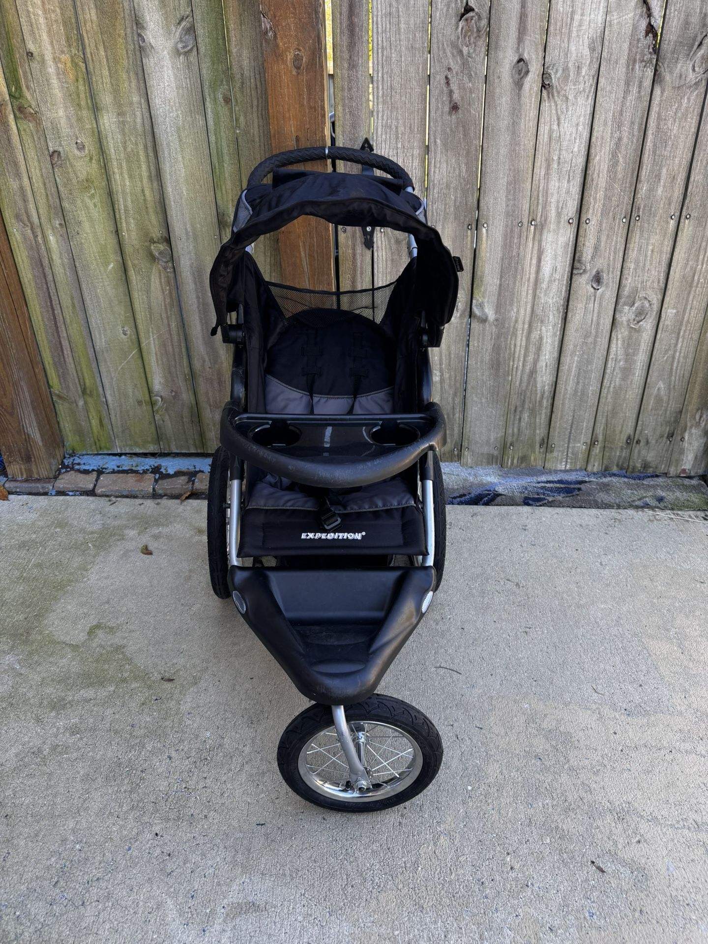 Baby Trend Expedition Jogger stroller. The stroller is a three-wheeled jogging stroller with a large canopy and a storage basket underneath. The front