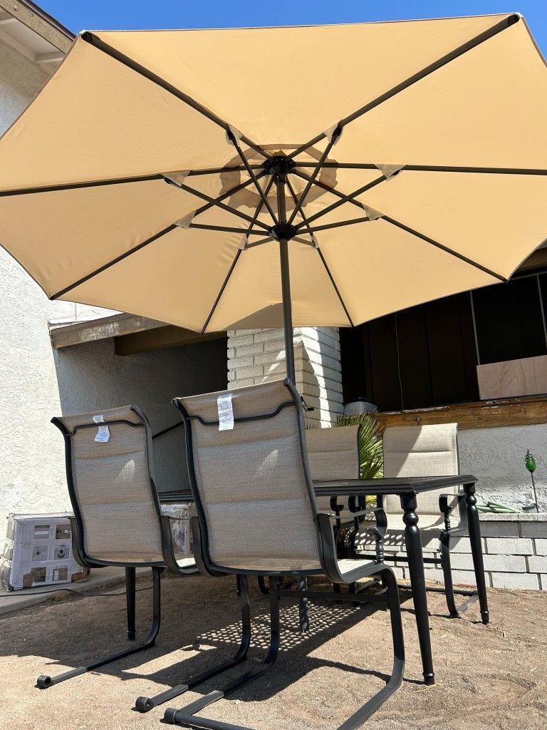 New patio dining set in good condition with 11 ft umbrella