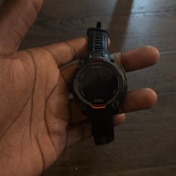 The product in the image is a Garmin Instinct 3 Solar rugged GPS smartwatch.
