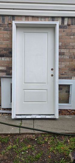 36x80 new! Front door solid core , framed with trim . Ready to install.