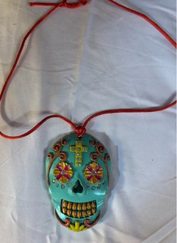Super cool brightly colored skull pendant on red leather cord.