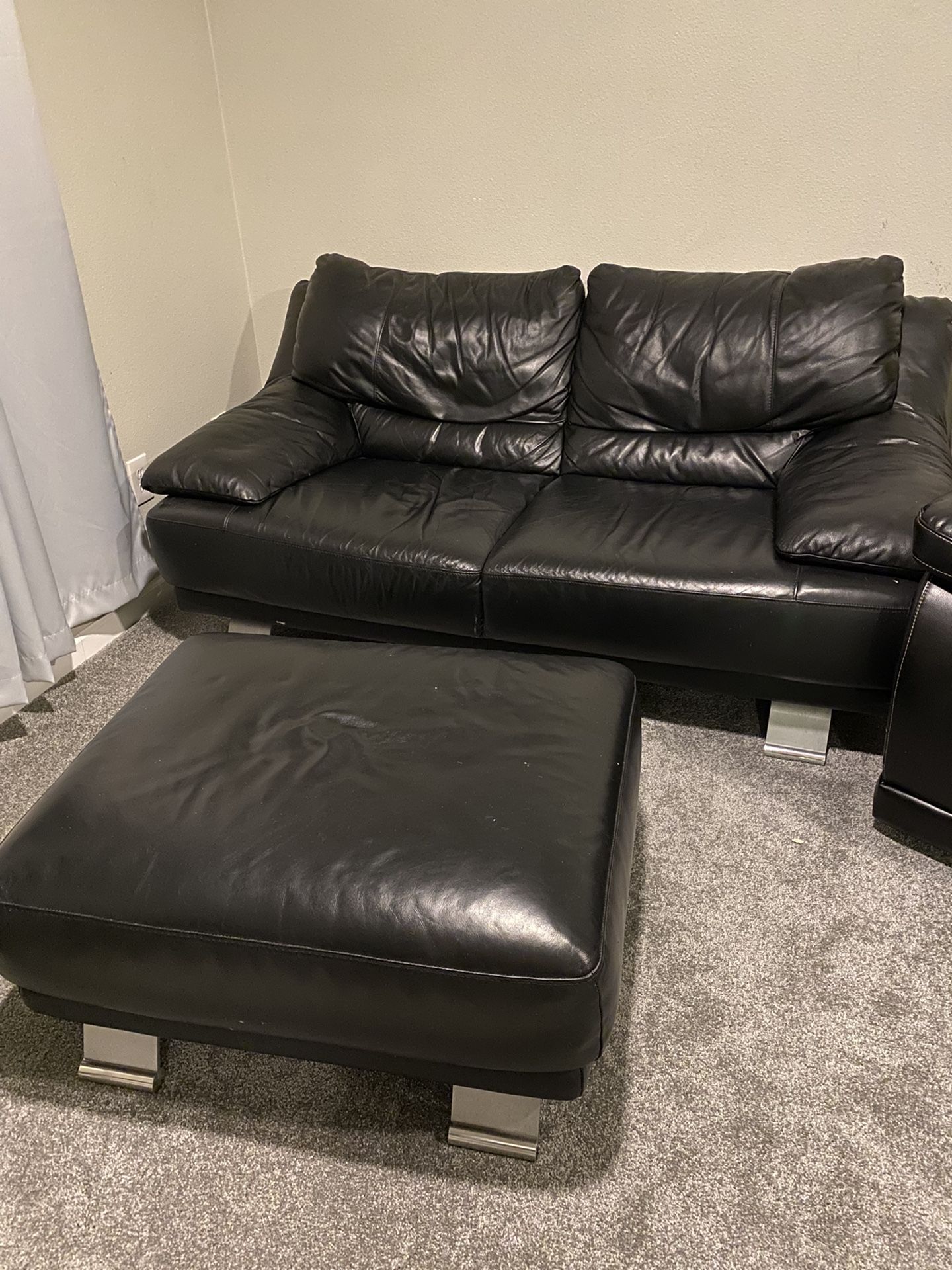 Black Leather Love Seat And Ottoman.