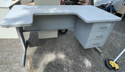 Grey metal and laminate top desk with built in file cabinet.  Northeast Tacoma near the Centre at Norpoint
